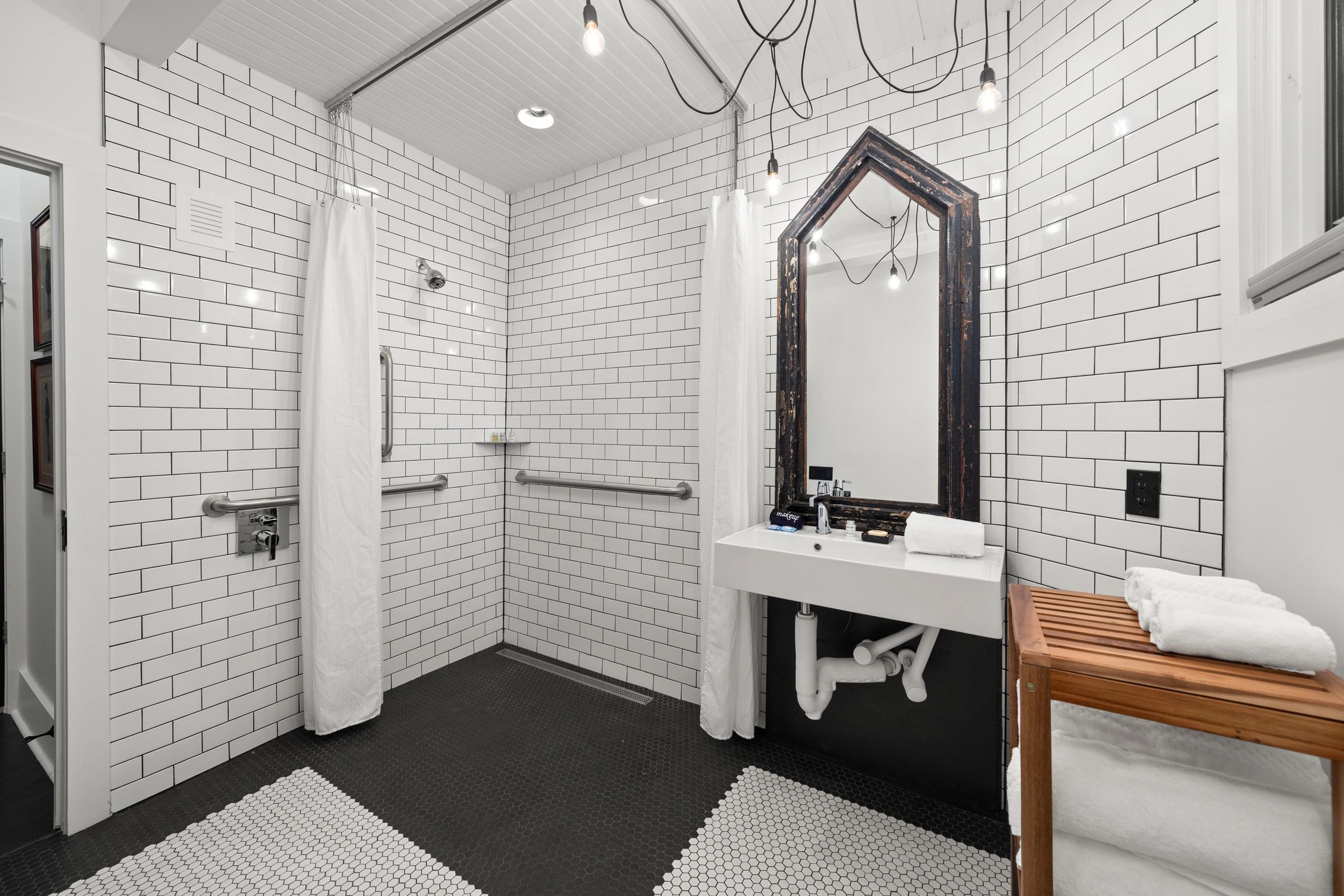 Spacious modern bathroom with white subway tiles and walk-in shower